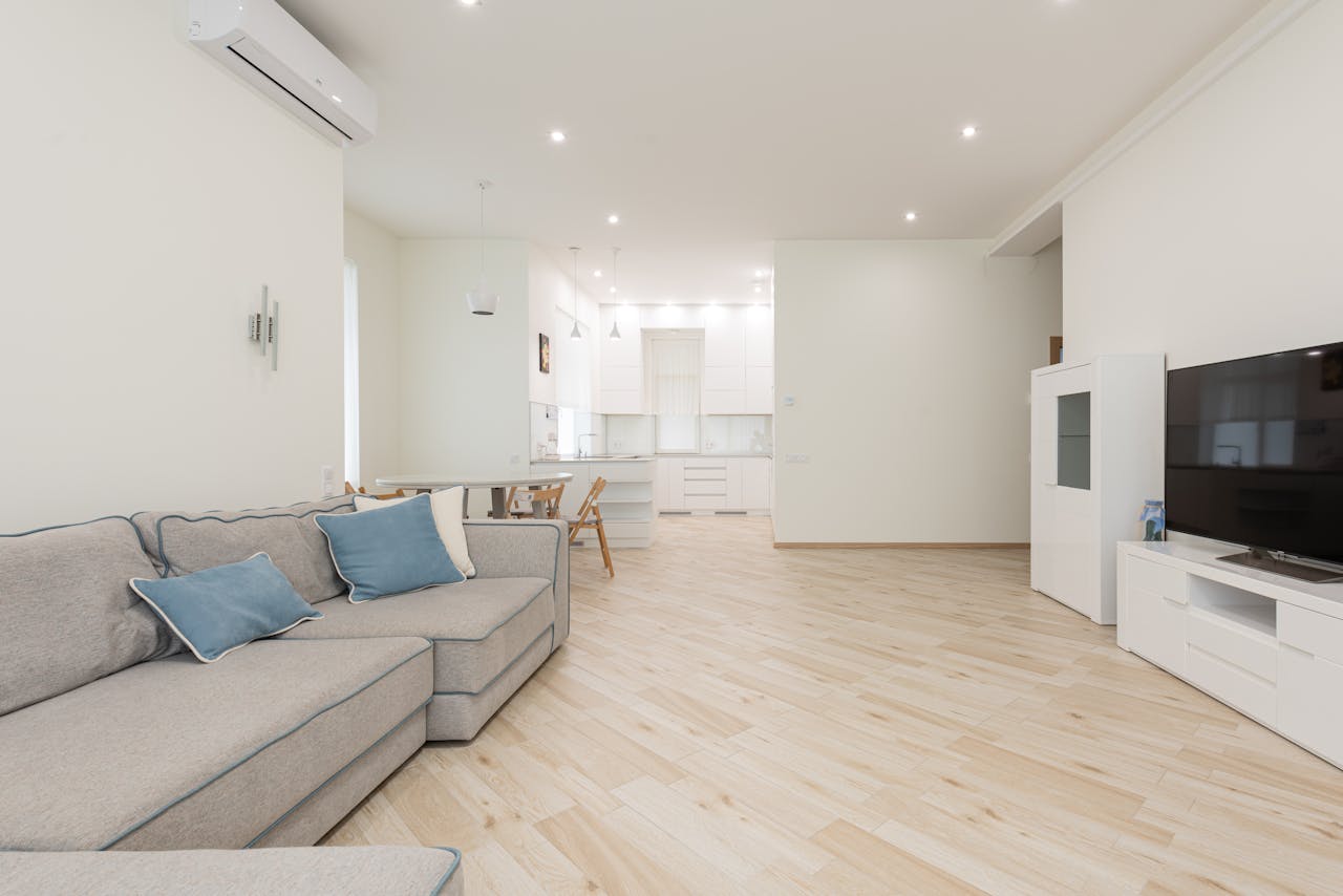 Modern apartment with spacious lounge with television and clean new laminate under bright luminous lights