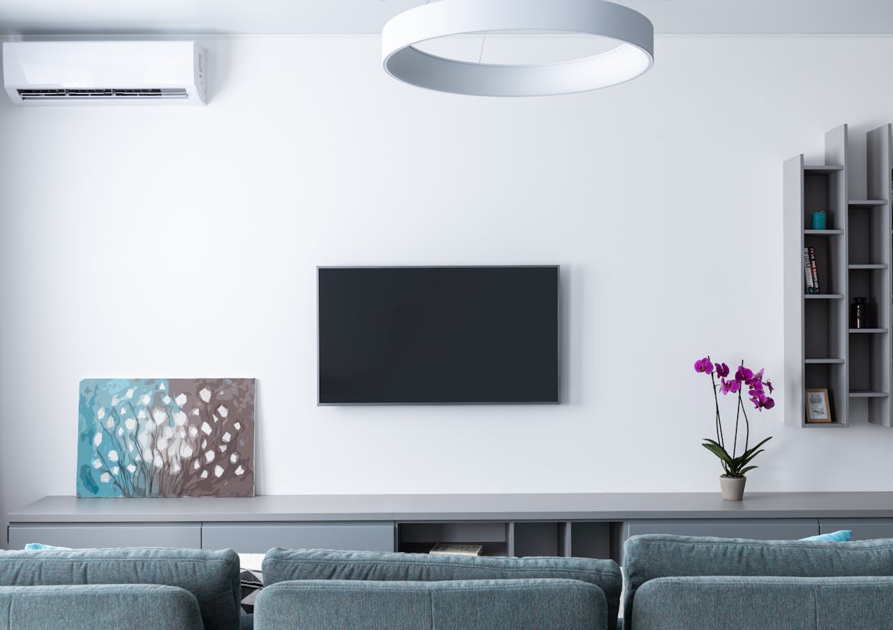 Contemporary living room decorated with purple flowers and rectangular shaped shelves handing on wall